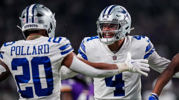 Nov 20, 2022; Minneapolis, Minnesota, USA; Dallas Cowboys quarterback Dak Prescott (4) celebrates a touchdown with running back Tony Pollard (20) during the third quarter against the Minnesota Vikings at U.S. Bank Stadium.